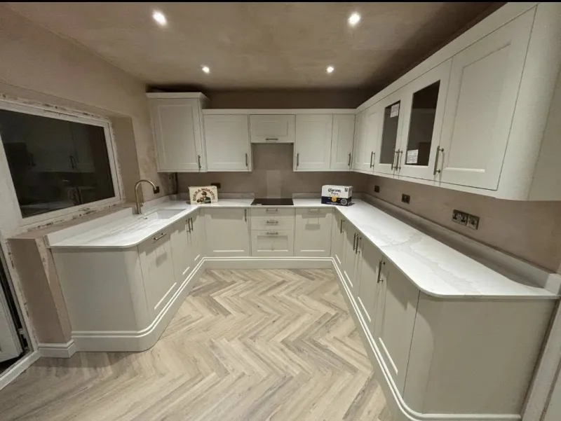 Cream kitchen with herringbone floor and LED plinth by AG Joinery Blackburn