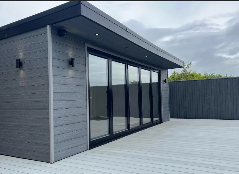 Grey composite garden room with bi-fold doors and composite decking by AG Joinery Blackburn