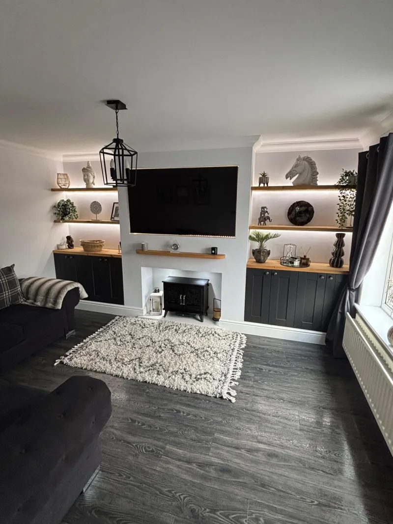 Media wall with oak floating shelves, LED lighting and electric stove by AG Joinery Blackburn with Darwen