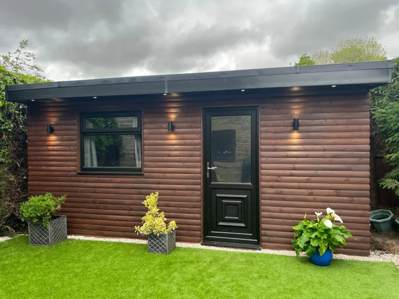 Completed timber garden room with dark door and wall lighting by AG Joinery Lancashire