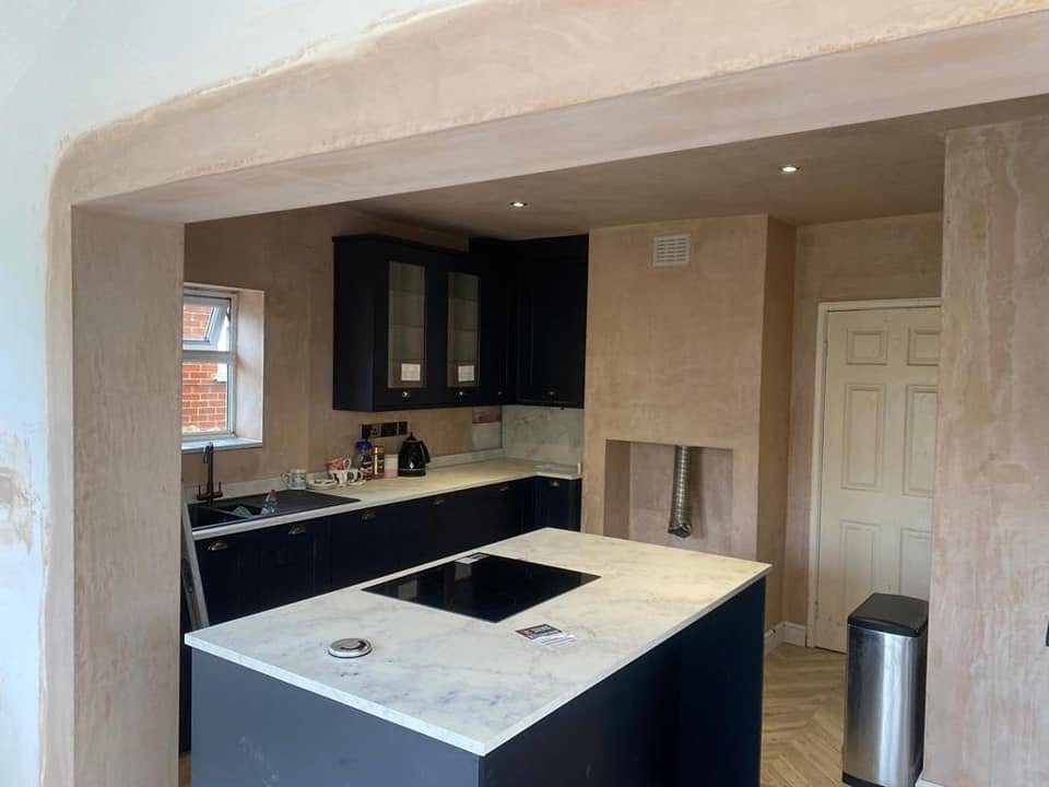 Dark navy kitchen with marble island by AG Joinery Blackburn